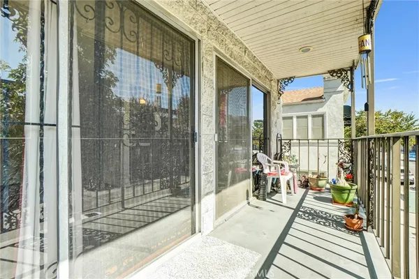 a view of a kitchen with white cabinets and refrigerator