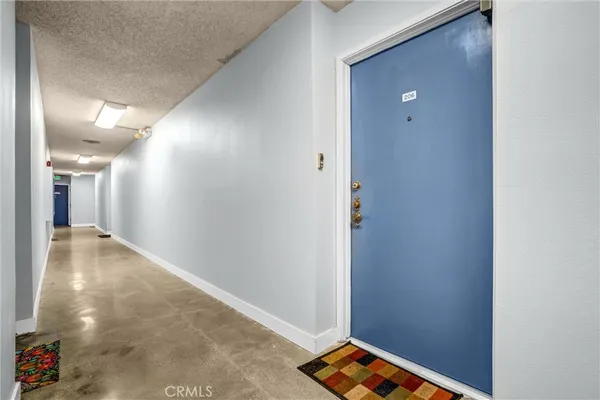 a view of a hallway to an empty room with closet and a window