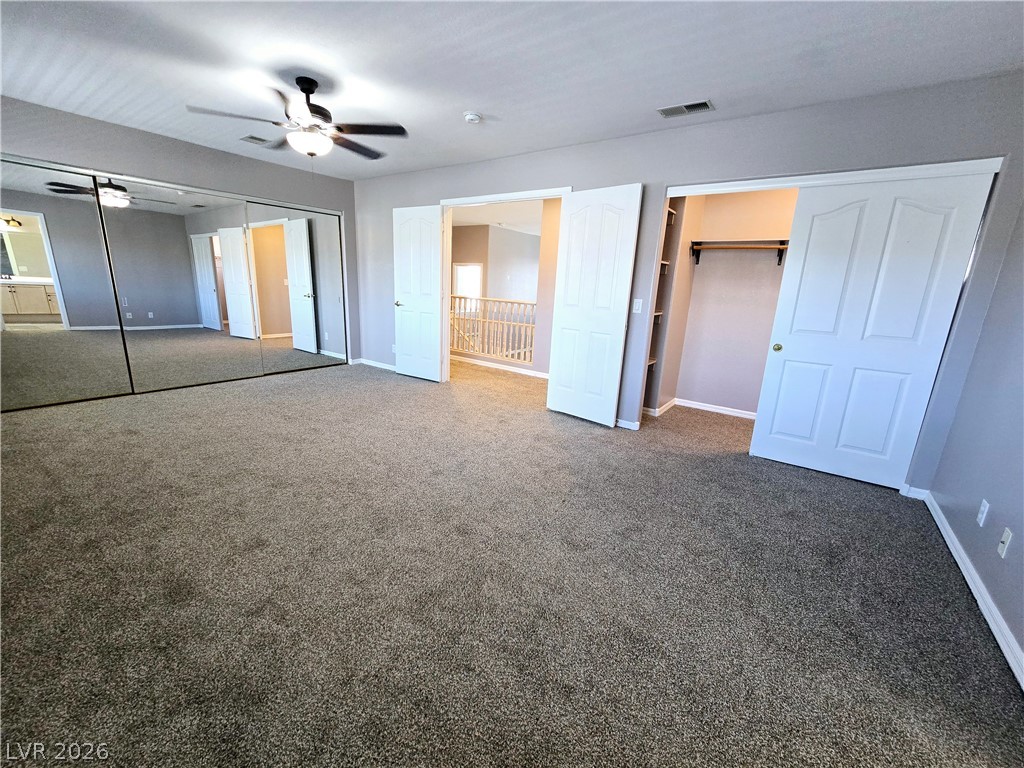 3759 Funston Way Las Vegas, NV 89129 - Photo 7 of 31 Plush carpet and a cooling ceiling fan outfit this generously proportioned bedroom.