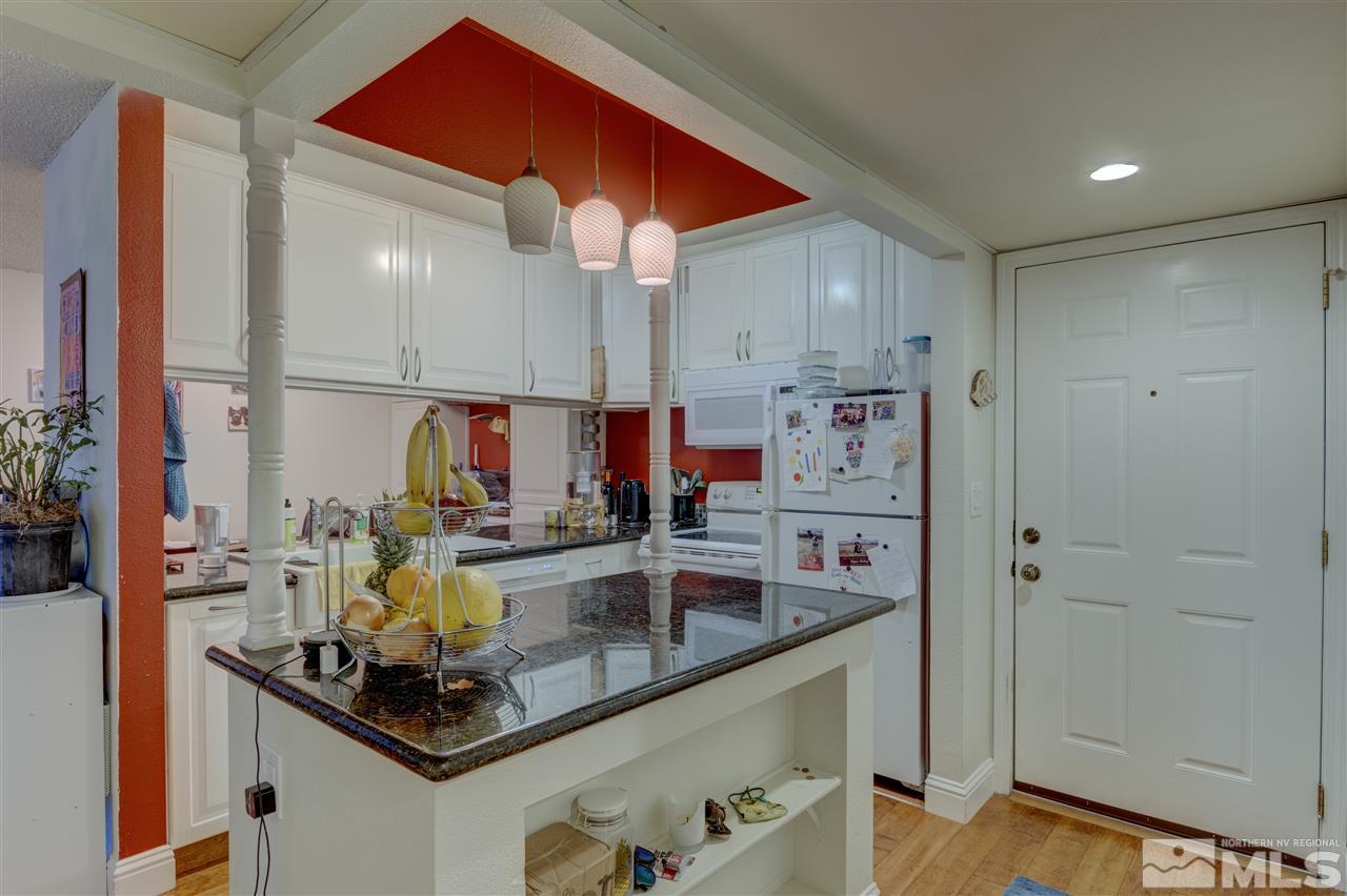 2700 Plumas Street, Unit 322 Reno, NV 89509 - Photo 11 of 18 a kitchen with kitchen island granite countertop a sink and cabinets