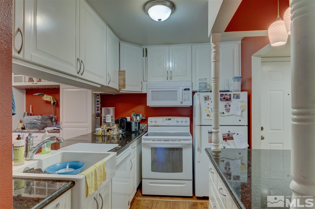 2700 Plumas Street, Unit 322 Reno, NV 89509 - Photo 13 of 18 a kitchen with stainless steel appliances granite countertop a sink and cabinets