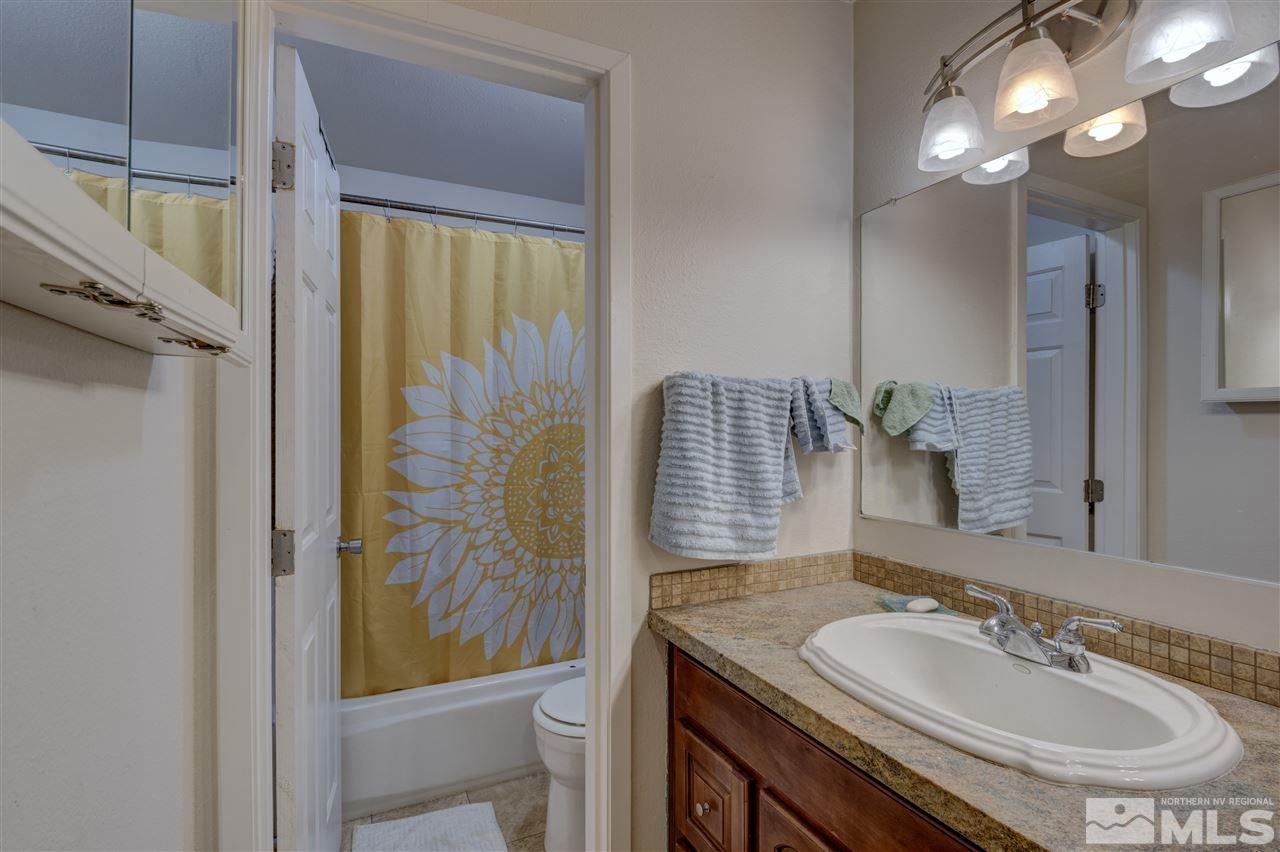 2700 Plumas Street, Unit 322 Reno, NV 89509 - Photo 7 of 18 a bathroom with a granite countertop sink a toilet and shower