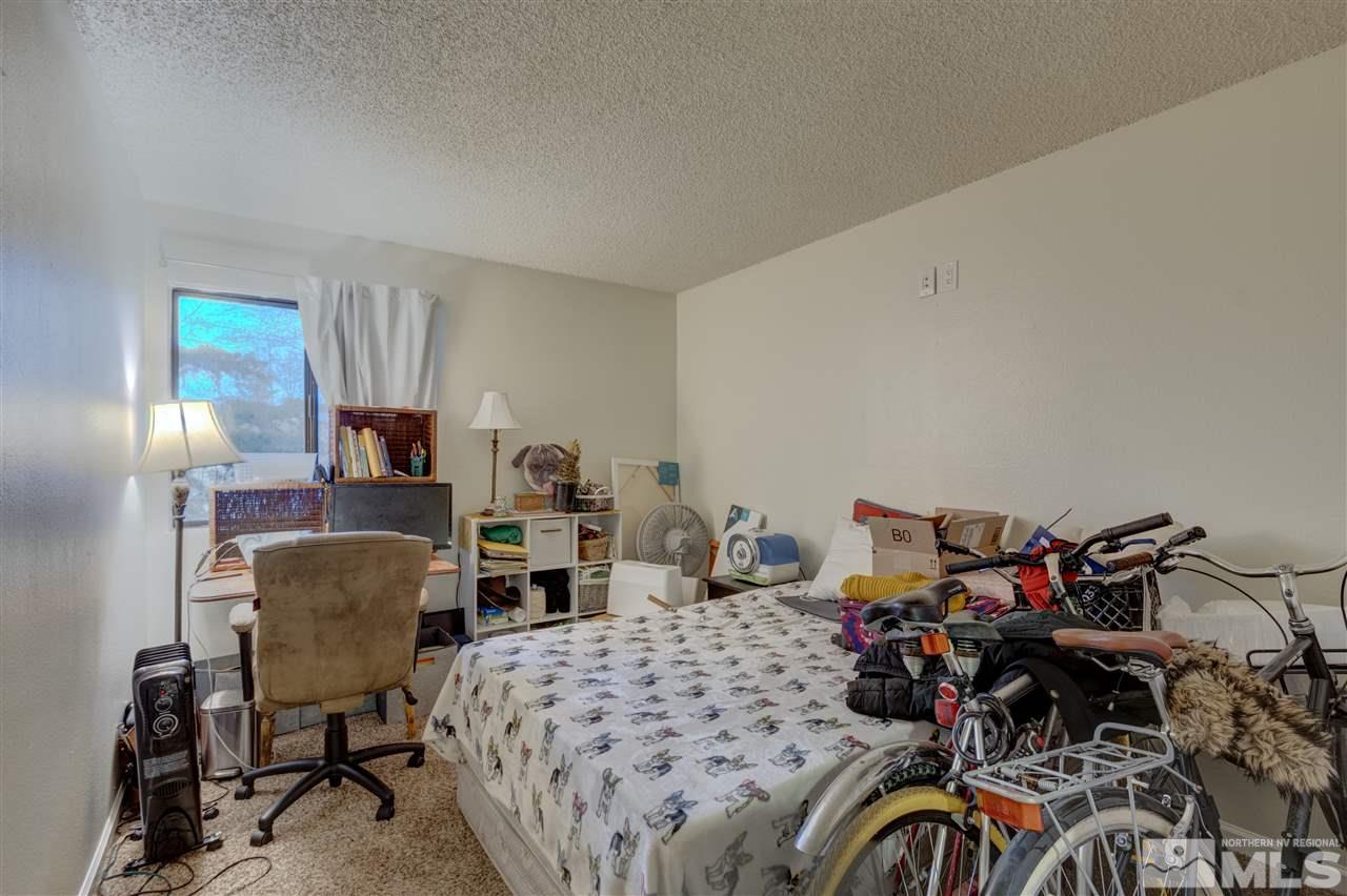 2700 Plumas Street, Unit 322 Reno, NV 89509 - Photo 10 of 18 a bedroom with furniture and a closet
