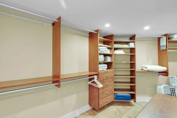 a bedroom with two beds and a dresser