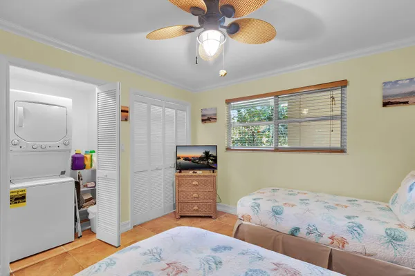 a bedroom with two beds and a chandelier