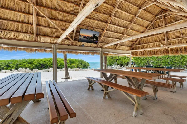 a view of a swimming pool with a patio and ocean view