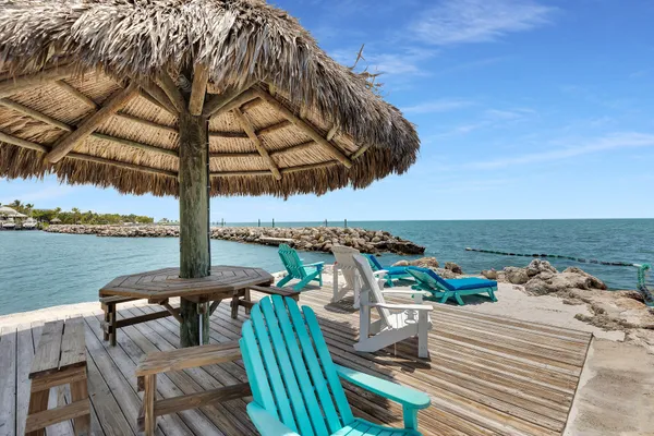 a view of balcony with chairs and wooden fence