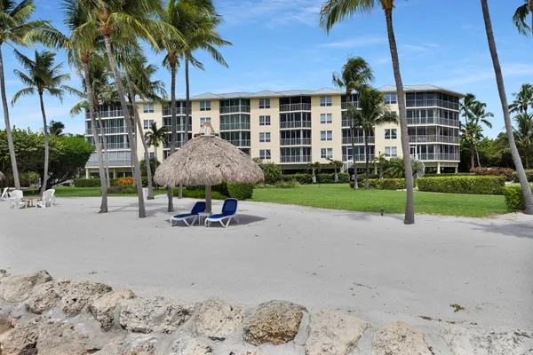 an aerial view of a house with a garden and lake view