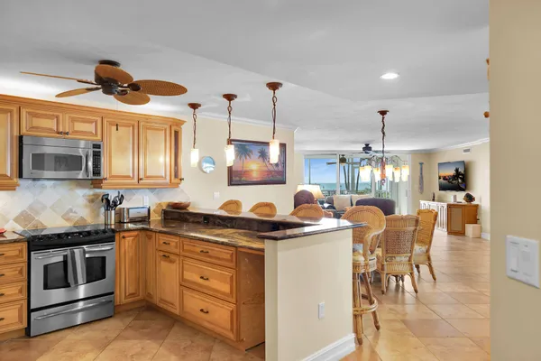 a kitchen with stainless steel appliances granite countertop a stove a sink and a refrigerator