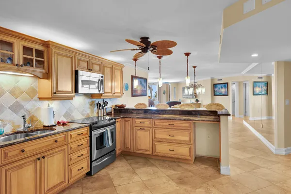 a kitchen with stainless steel appliances granite countertop a sink and cabinets