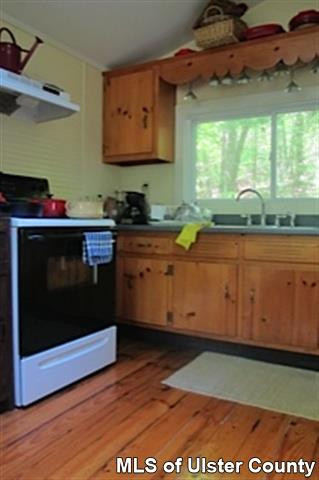 20 Sherman Road Woodstock, NY 12498 - Photo 14 of 17 a kitchen with stainless steel appliances granite countertop a stove a sink and a microwave