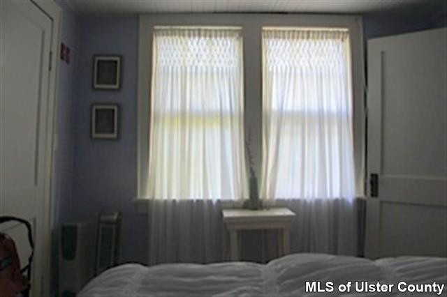20 Sherman Road Woodstock, NY 12498 - Photo 16 of 17 a bedroom with a bed and a window