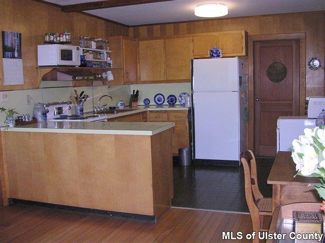 20 Sherman Road Woodstock, NY 12498 - Photo 5 of 17 a kitchen with refrigerator and cabinets