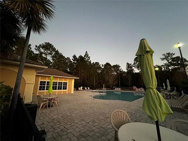 a backyard of a house with table and chairs