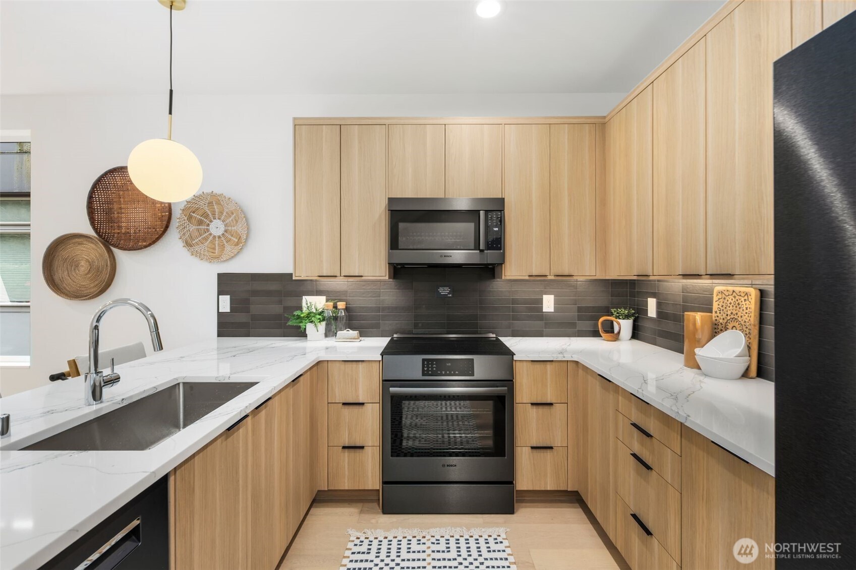 4123 B Chilberg Avenue Southwest Seattle, WA 98116 - Photo 11 of 25 a kitchen with a sink cabinets and stainless steel appliances