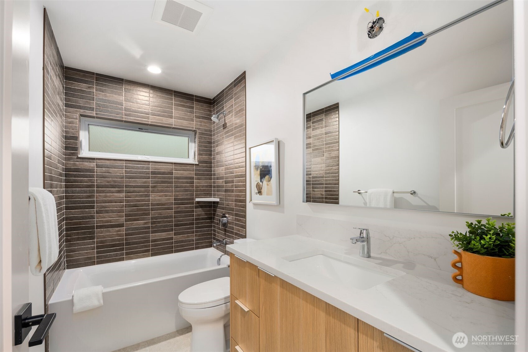 4123 B Chilberg Avenue Southwest Seattle, WA 98116 - Photo 20 of 25 a bathroom with a granite countertop sink a toilet a mirror and shower