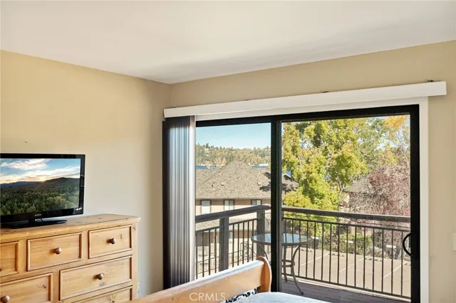 a view of a room with wooden floor and windows