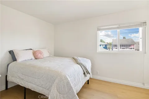 a bedroom with a bed and glass window