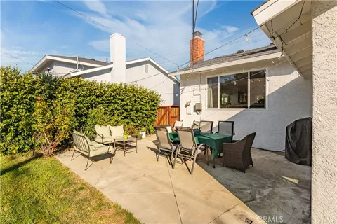 a view of a patio with table and chairs and potted plants