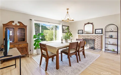 a dining room with furniture a chandelier and wooden floor