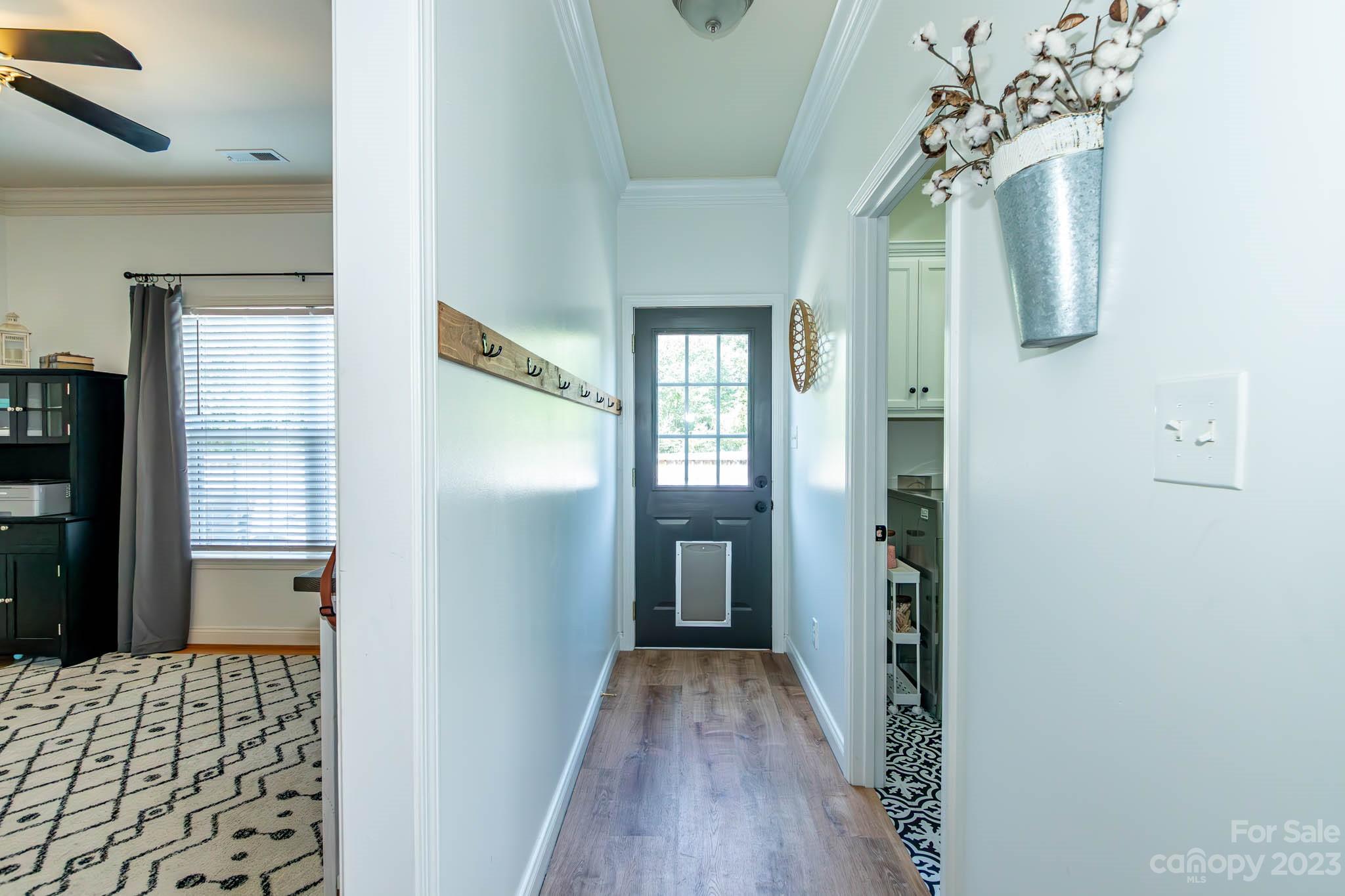 2707 Falling Leaf Court Monroe, NC 28110 - Photo 14 of 44 a view of a hallway with wooden floor and staircase