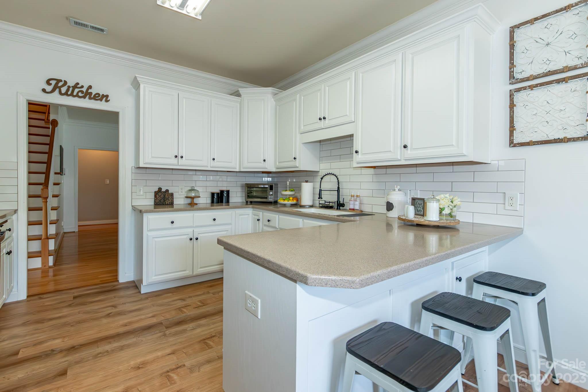 2707 Falling Leaf Court Monroe, NC 28110 - Photo 20 of 44 a kitchen with stainless steel appliances granite countertop a sink stove and refrigerator