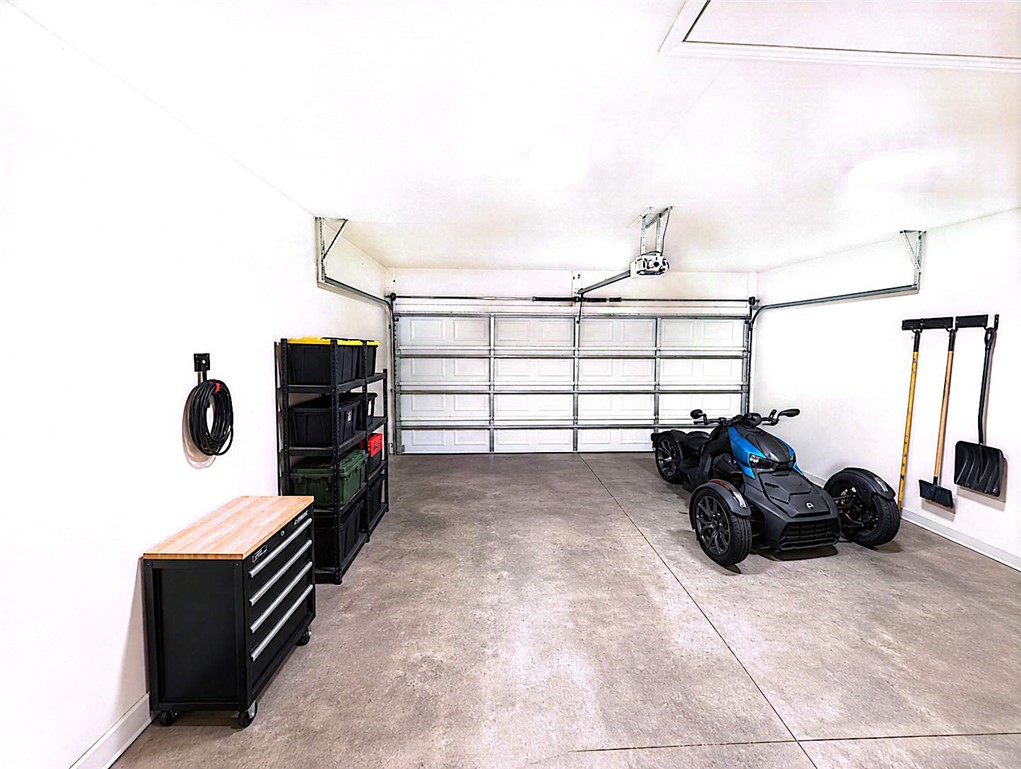 124 Woodbridge Court Anderson, SC 29621 - Photo 9 of 15 This spacious garage offers ample room for vehicles and storage, featuring a durable concrete floor.