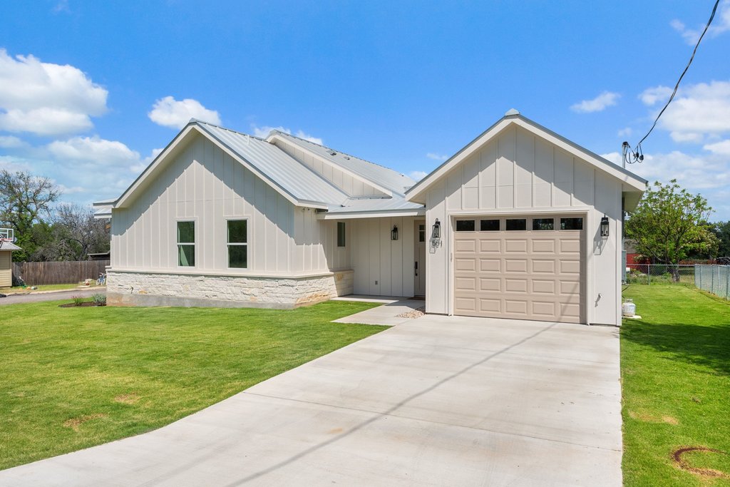 501 Ranchview Drive Johnson City, TX 78636 - Photo 2 of 28 a front view of a house with a yard and garage