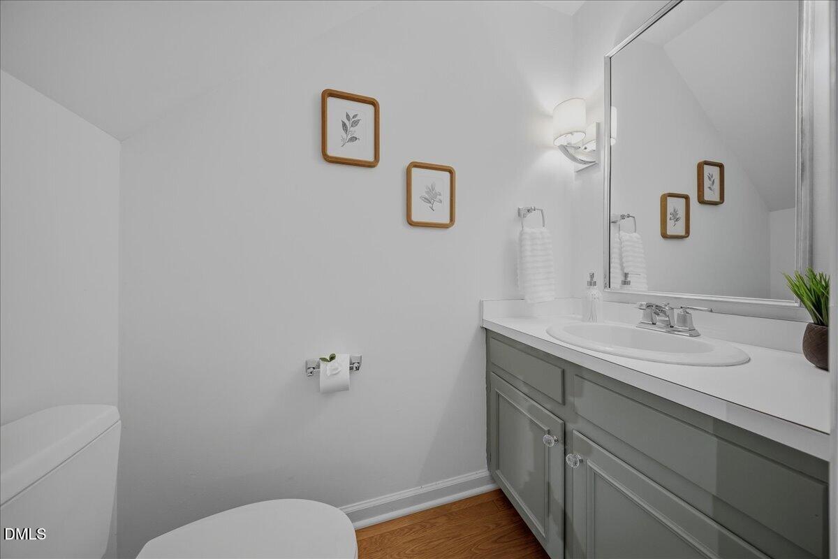 2834 Wayland Drive Raleigh, NC 27608 - Photo 11 of 26 a bathroom with a granite countertop sink mirror vanity and toilet