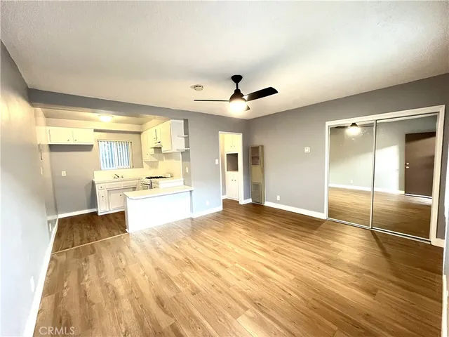 a view of a kitchen with a sink and a refrigerator