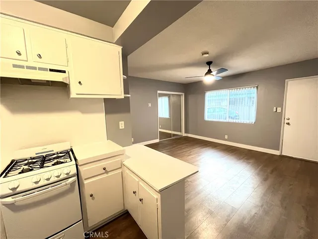 a open kitchen with a sink stove and refrigerator