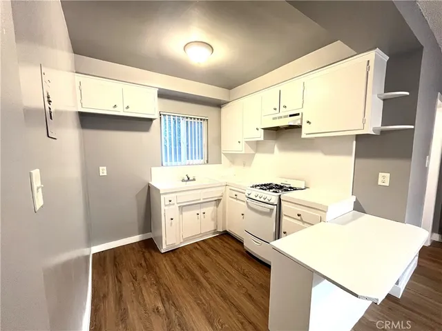 a kitchen with a stove a sink and a refrigerator