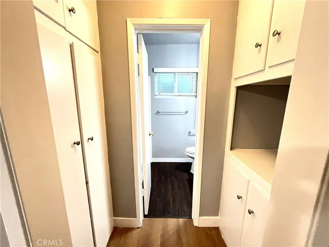 a view of a hallway with wooden floor