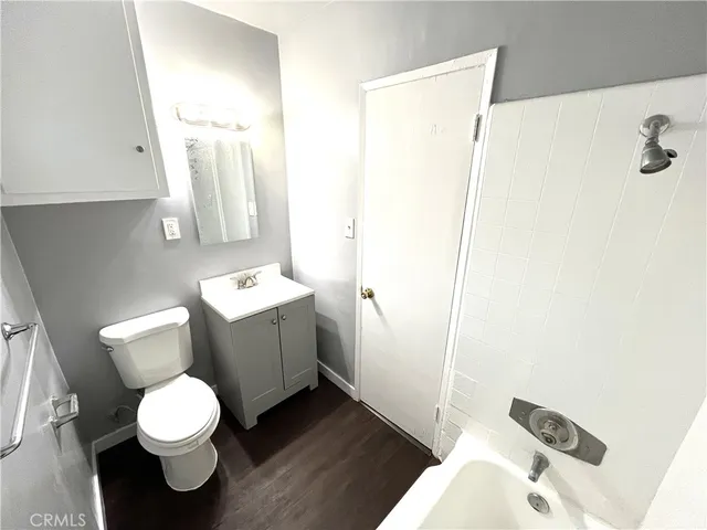 a white toilet sitting next to a bathroom sink