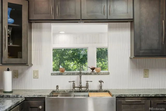 a kitchen with a sink cabinets and window