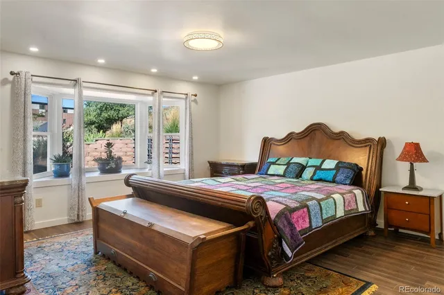 a bedroom with a bed and a large window