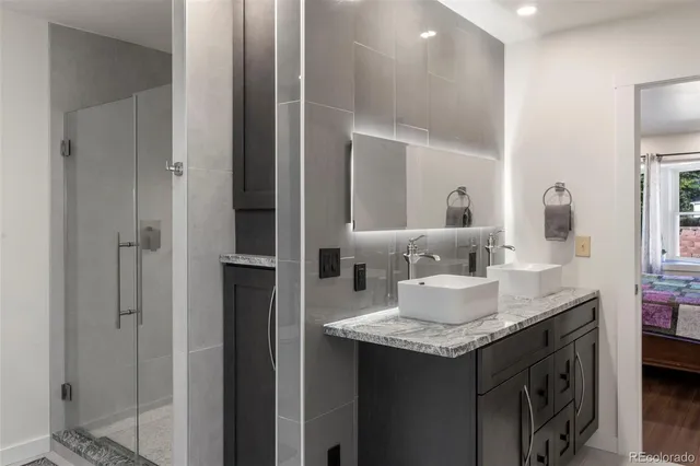 a bathroom with a granite countertop sink and a mirror
