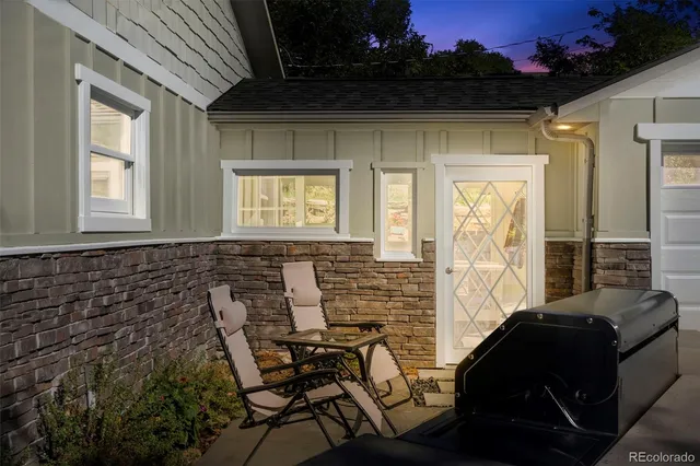 a view of a patio with a table and chairs