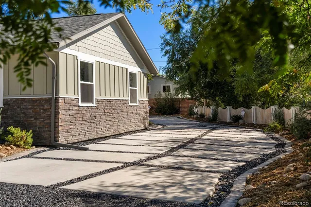 a view of a house with backyard and sitting area