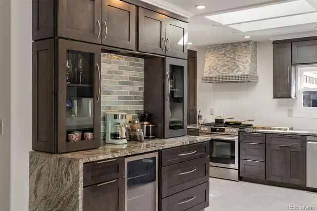 a kitchen with stainless steel appliances granite countertop a stove and a sink