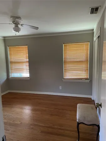 a view of room with window and wooden floor