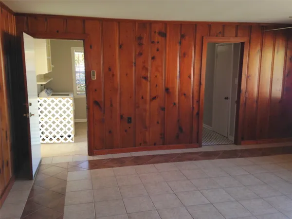 a view of an entryway with wooden walls