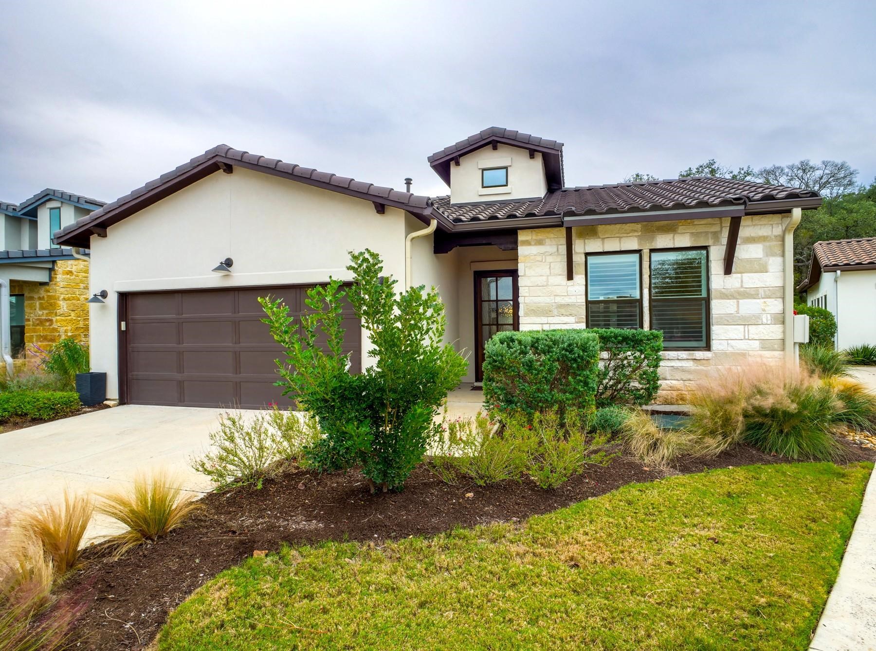 115 Rivalto Drive Horseshoe Bay, TX 78657 - Photo 19 of 29 a front view of a house with garden