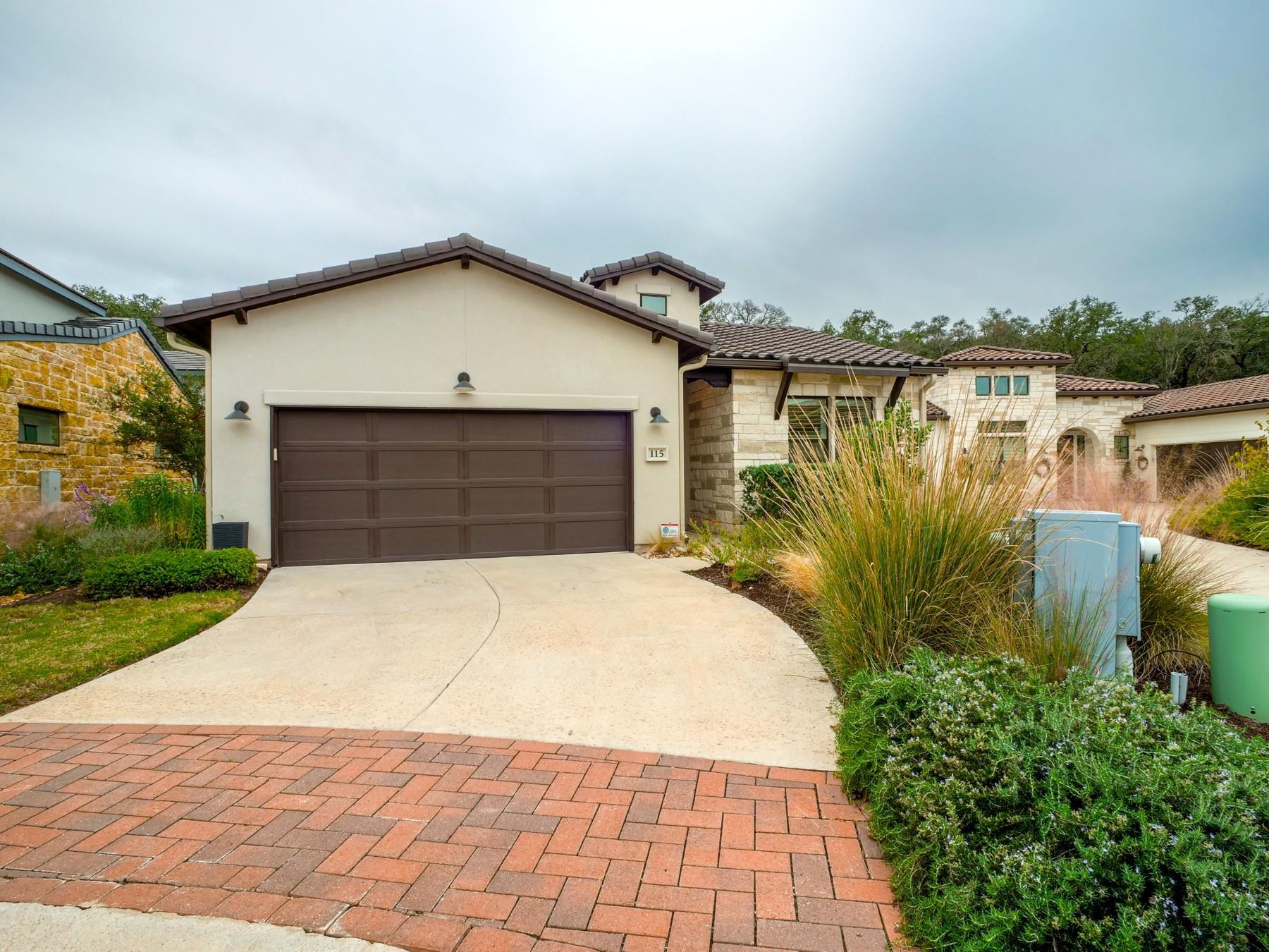 115 Rivalto Drive Horseshoe Bay, TX 78657 - Photo 20 of 29 a front view of a house with a yard and garage