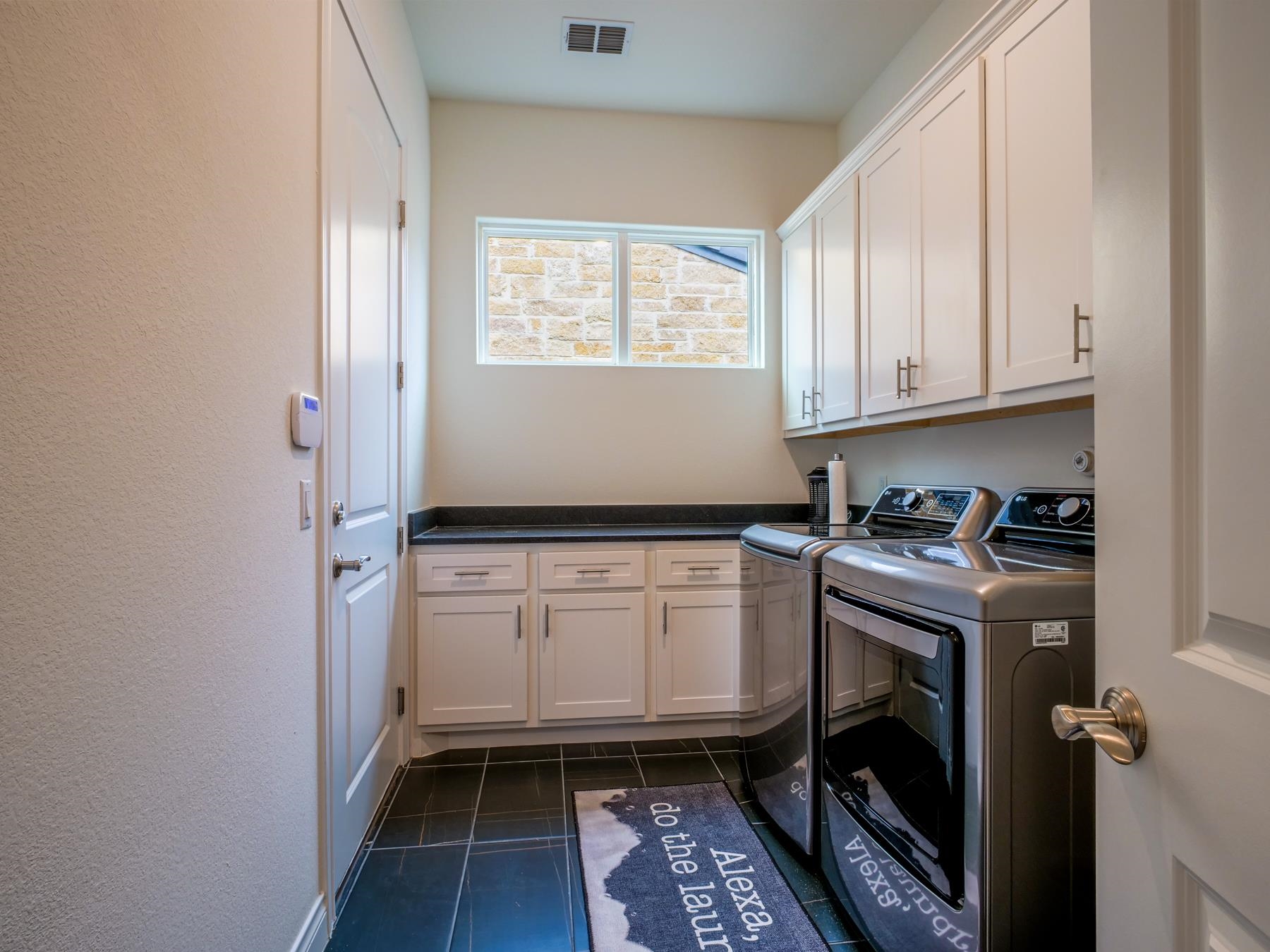 115 Rivalto Drive Horseshoe Bay, TX 78657 - Photo 28 of 29 a kitchen with granite countertop a sink a stove and cabinets