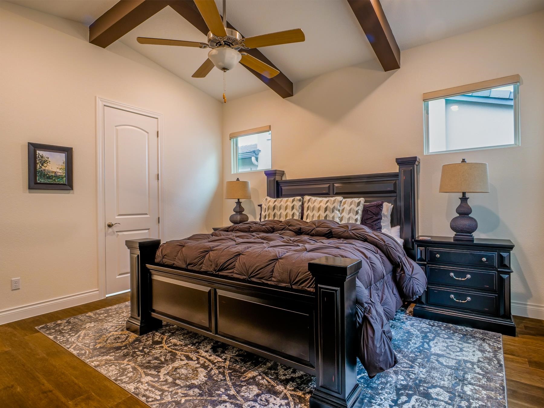 115 Rivalto Drive Horseshoe Bay, TX 78657 - Photo 10 of 29 a bedroom with a bed and a chandelier