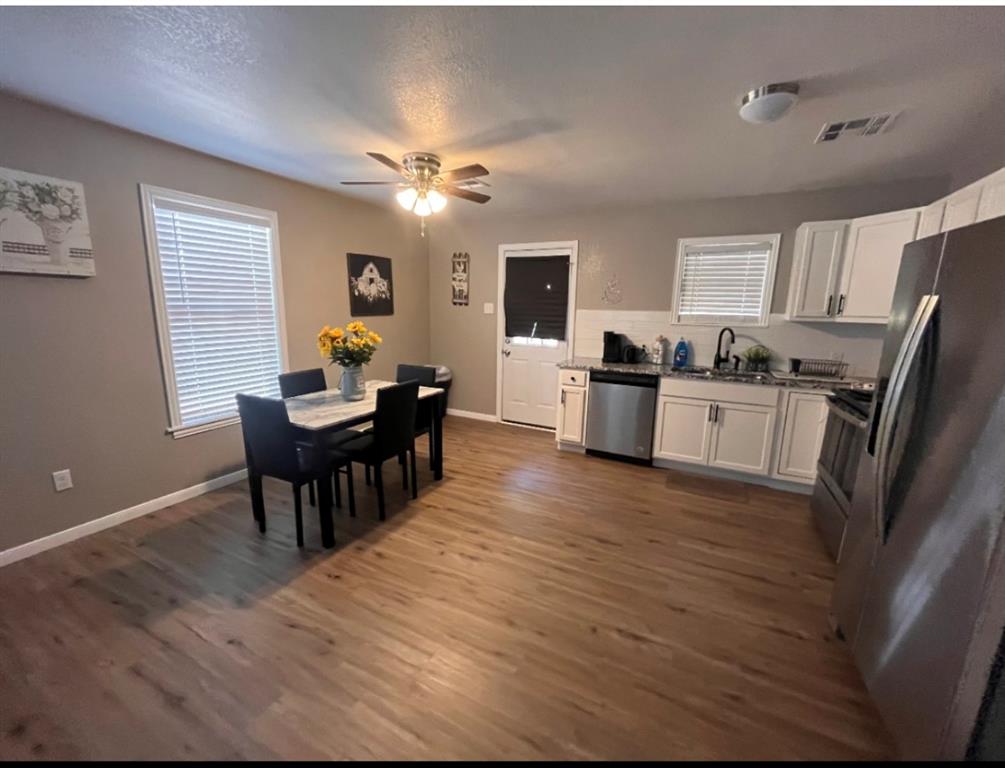 3209 North 23rd Street Waco, TX 76708 - Photo 3 of 8 a view of a dining room with furniture window and wooden floor