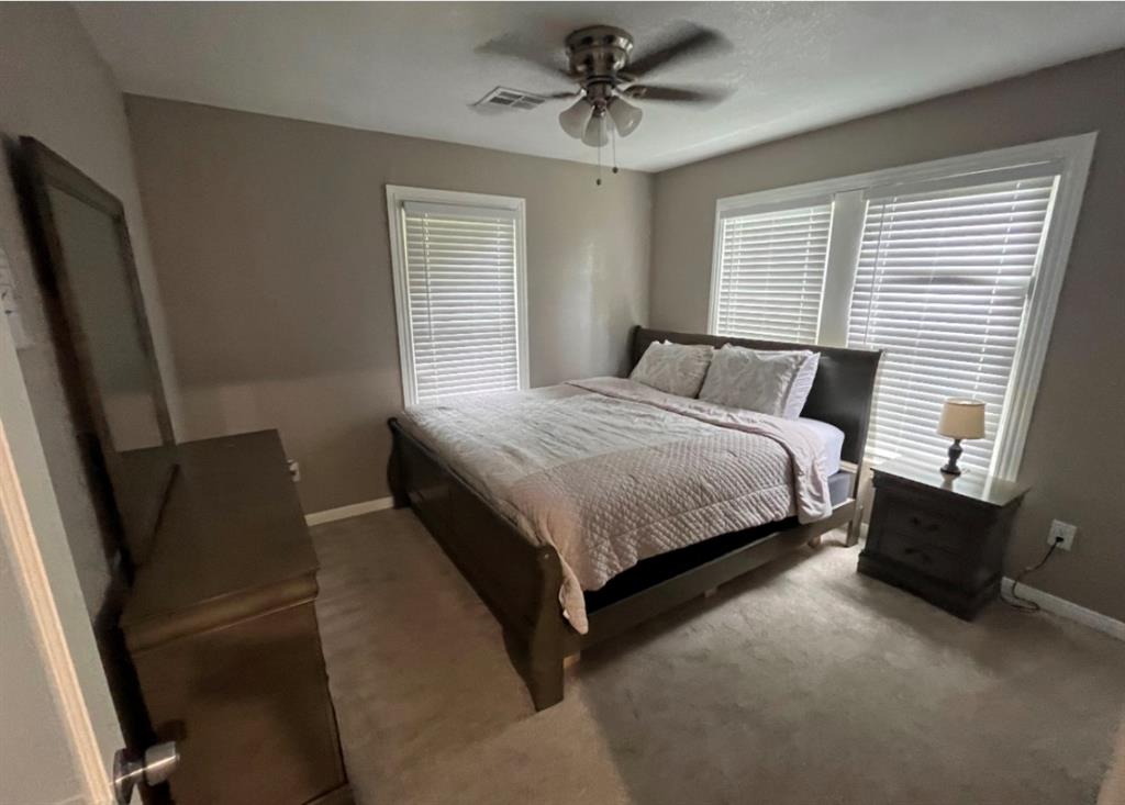3209 North 23rd Street Waco, TX 76708 - Photo 6 of 8 a bedroom with a bed rug and window