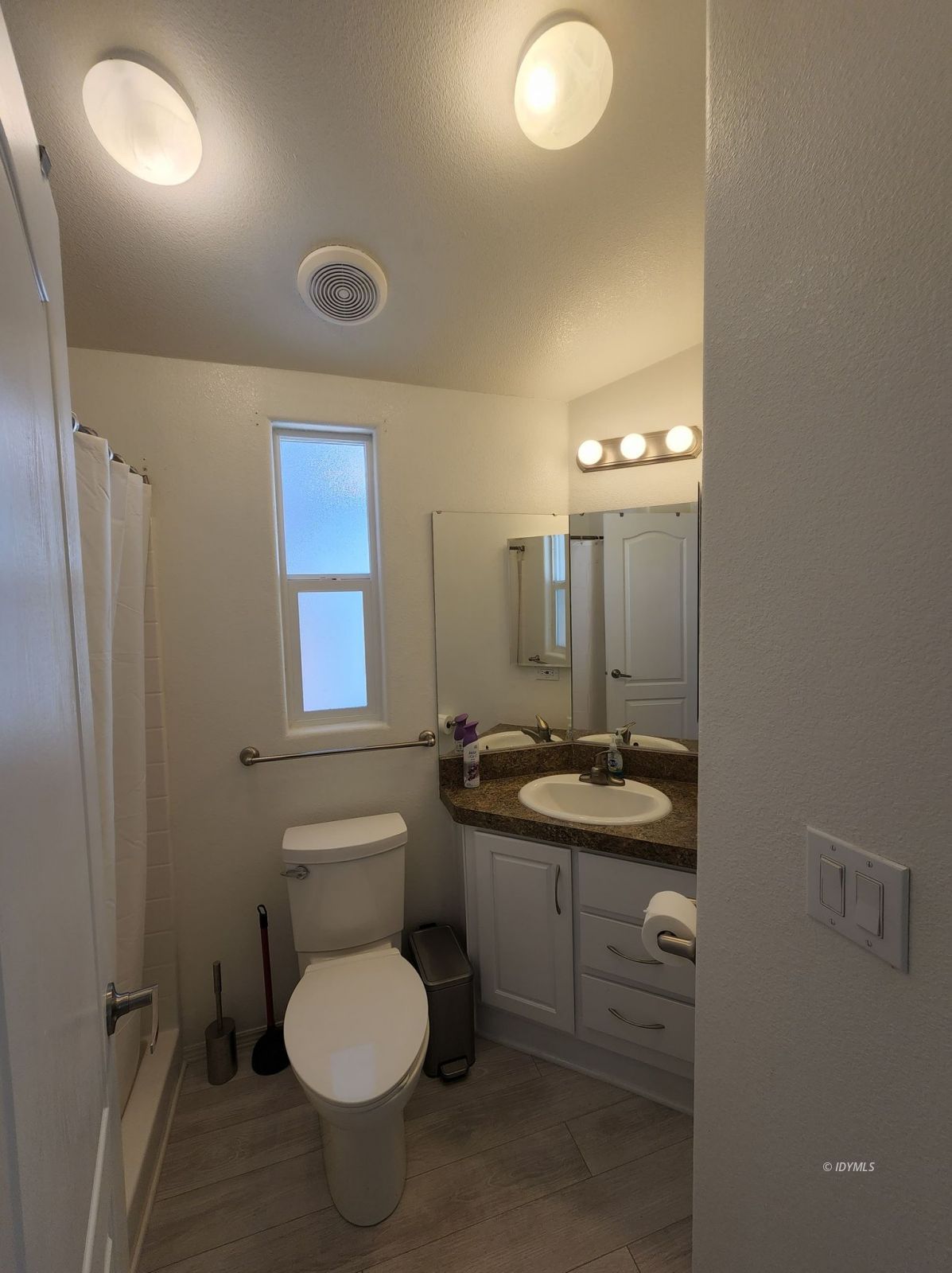 25955 Highway 243, Unit 45 Idyllwild, CA 92549 - Photo 15 of 25 a bathroom with a granite countertop toilet sink and mirror