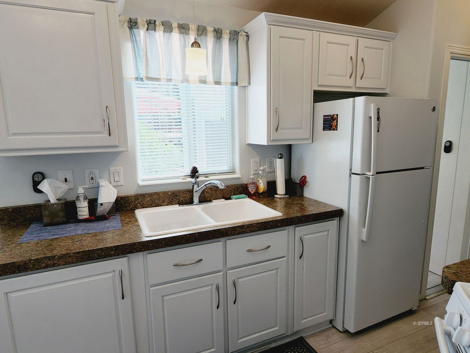 25955 Highway 243, Unit 45 Idyllwild, CA 92549 - Photo 8 of 25 a kitchen with stainless steel appliances granite countertop a sink a refrigerator and a white cabinets